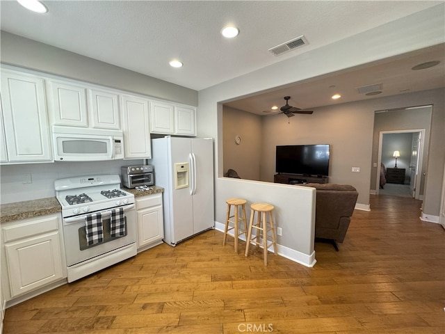 896 Poppyseed Way, Hemet, CA 92545 - kitchen with white appliances, open floor plan, light wood finished floors, white cabinets, and ceiling fan