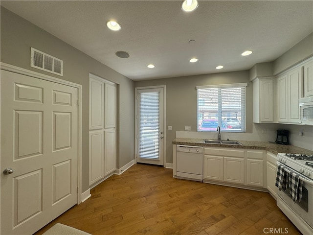 896 Poppyseed Way, Hemet, CA 92545 - kitchen featuring white appliances, white cabinetry, light wood-type flooring, recessed lighting, and light countertops