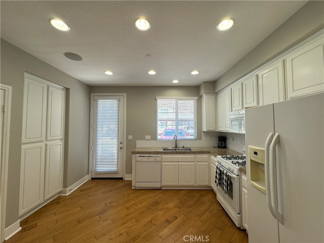 896 Poppyseed Way, Hemet, CA 92545 - kitchen with white appliances, light wood-style flooring, white cabinets, and recessed lighting