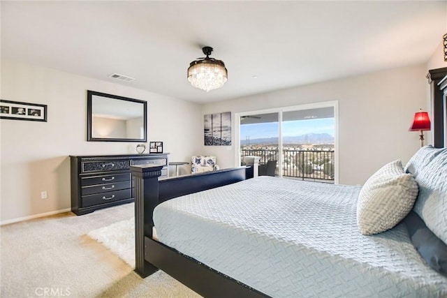 35212 Smith Ave, Beaumont, CA 92223 - bedroom featuring access to exterior, light carpet, and a chandelier