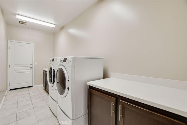 35212 Smith Ave, Beaumont, CA 92223 - washroom with cabinet space, washer and clothes dryer, and light tile patterned flooring