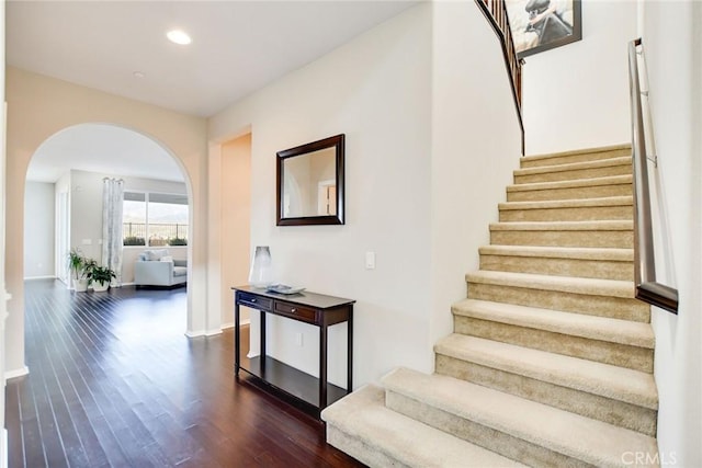 35212 Smith Ave, Beaumont, CA 92223 - stairs featuring arched walkways, wood finished floors, and recessed lighting