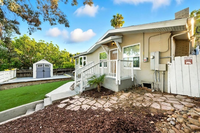493133 Auburn, San Diego, CA 92105 - bungalow-style home featuring a storage shed, a fenced backyard, stucco siding, and a chimney