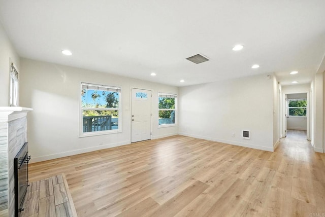 493133 Auburn, San Diego, CA 92105 - unfurnished living room with light wood-style floors, a fireplace, and recessed lighting