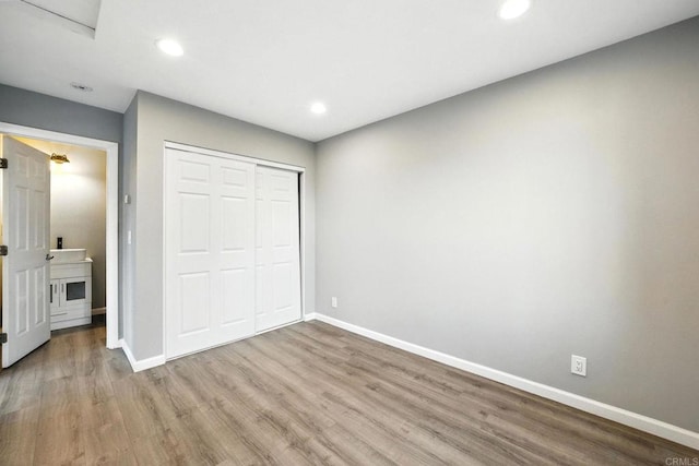 493133 Auburn, San Diego, CA 92105 - unfurnished bedroom featuring wood finished floors, a closet, and recessed lighting