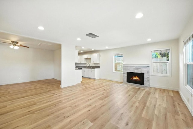 493133 Auburn, San Diego, CA 92105 - unfurnished living room featuring light wood-type flooring, a fireplace with flush hearth, recessed lighting, and ceiling fan