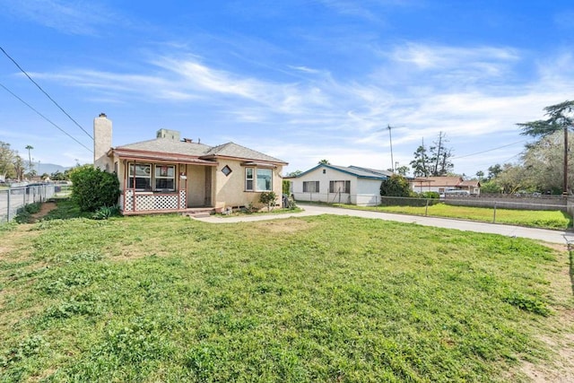 1065 Stevenson St Unit A & B, Colton, CA 92324 - bungalow-style house featuring concrete driveway, stucco siding, and a chimney