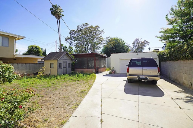 317 N Primrose Ave, Alhambra, CA 91801 - view of yard with driveway, a sunroom, a garage, and a storage shed