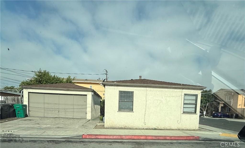 358 E 53rd St, Long Beach, CA 90805 - ranch-style home with an outbuilding, a garage, and stucco siding