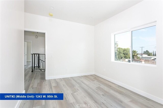 1241 W 95th St, Los Angeles, CA 90044 - spare room featuring wood finished floors and baseboards
