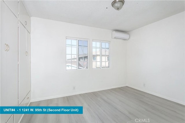 1241 W 95th St, Los Angeles, CA 90044 - unfurnished bedroom with wood finished floors and a wall unit AC