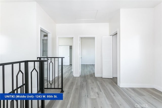 1241 W 95th St, Los Angeles, CA 90044 - hallway featuring an upstairs landing, wood finished floors, and attic access