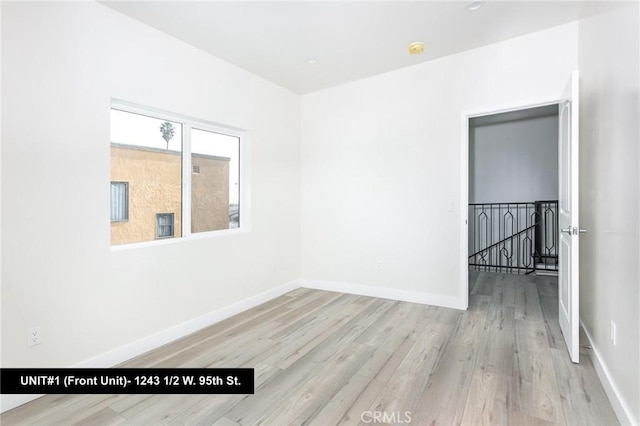 1241 W 95th St, Los Angeles, CA 90044 - unfurnished room with wood finished floors and a smoke detector