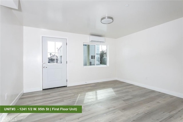 1241 W 95th St, Los Angeles, CA 90044 - unfurnished room featuring a wall mounted air conditioner and wood finished floors