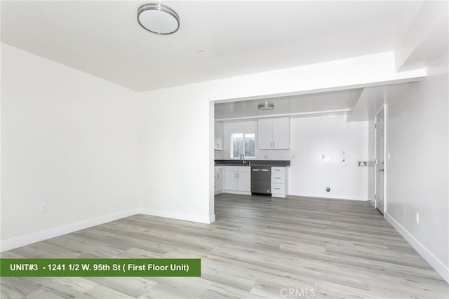 1241 W 95th St, Los Angeles, CA 90044 - unfurnished living room featuring light wood-type flooring