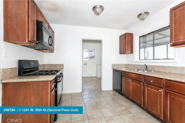 1241 W 95th St, Los Angeles, CA 90044 - kitchen featuring black appliances, healthy amount of natural light, light countertops, and a textured ceiling