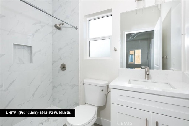 1241 W 95th St, Los Angeles, CA 90044 - full bathroom with vanity, a marble finish shower, and marble look tiles