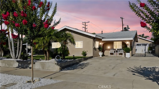 2901 Huston St, Pomona, CA 91767 - view of front facade featuring stucco siding, a gate, and concrete driveway