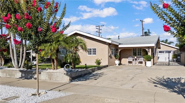 2901 Huston St, Pomona, CA 91767 - view of front facade with stucco siding, a gate, and concrete driveway