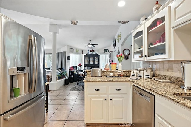 1115 Chennault Ave, Clovis, CA 93611 - kitchen featuring appliances with stainless steel finishes, a peninsula, a ceiling fan, glass insert cabinets, and light stone counters