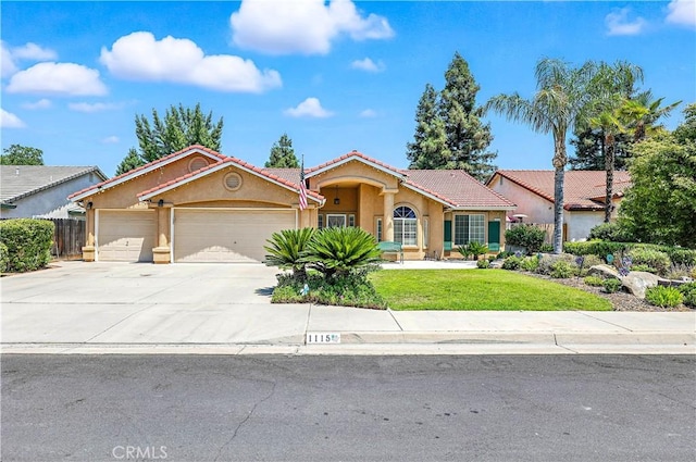 1115 Chennault Ave, Clovis, CA 93611 - mediterranean / spanish-style house featuring a garage, stucco siding, a tiled roof, and concrete driveway