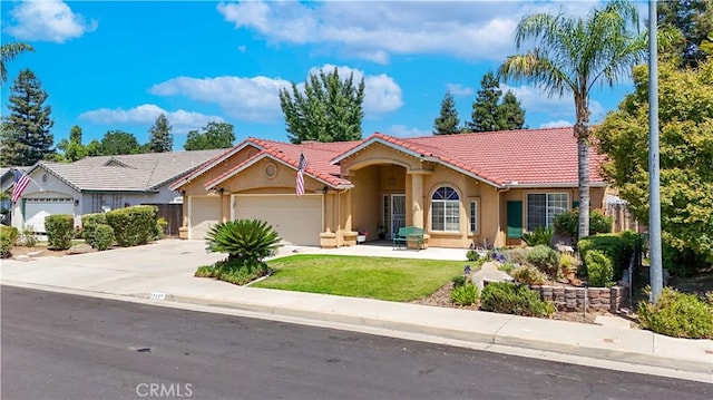 1115 Chennault Ave, Clovis, CA 93611 - mediterranean / spanish house with a garage, stucco siding, a tile roof, and concrete driveway
