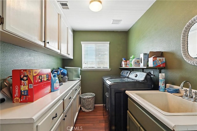 1115 Chennault Ave, Clovis, CA 93611 - laundry room featuring washer and dryer, cabinet space, dark wood-style flooring, and a textured wall