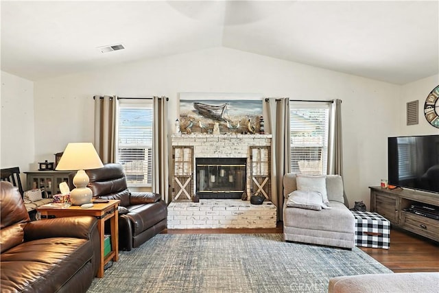 1115 Chennault Ave, Clovis, CA 93611 - living area featuring lofted ceiling, wood finished floors, and a brick fireplace