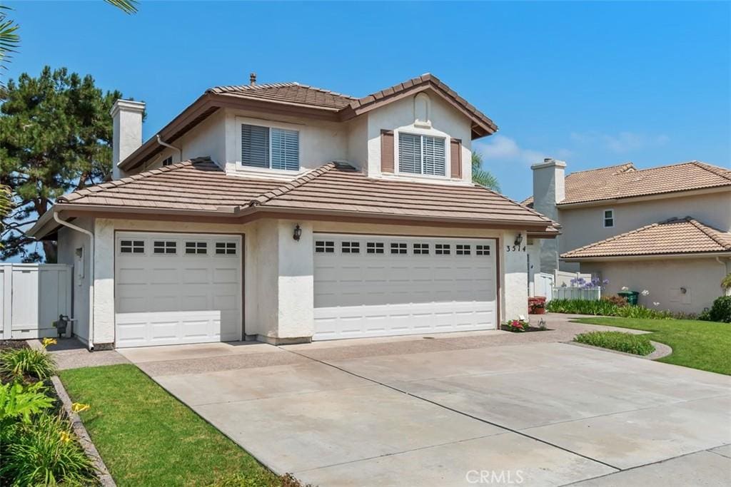 3514 Sitio Baya, Carlsbad, CA 92009 - traditional-style home with a tile roof, stucco siding, concrete driveway, and a chimney