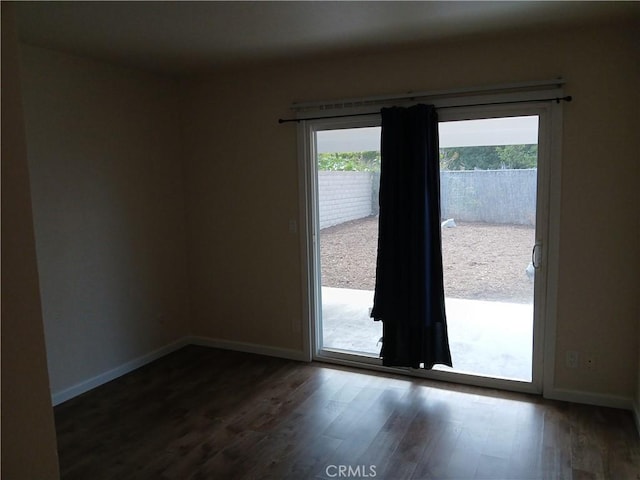 4493 Estada, Oceanside, CA 92057 - unfurnished room featuring dark wood-style flooring and baseboards