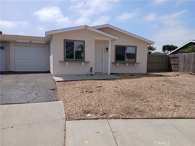 4493 Estada, Oceanside, CA 92057 - view of front of property featuring asphalt driveway, a garage, and stucco siding