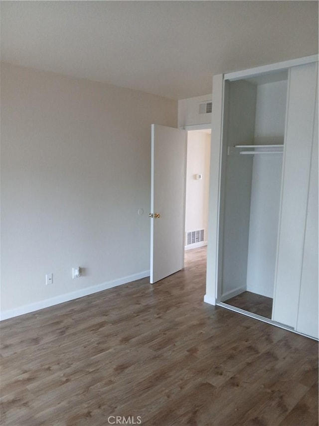 4493 Estada, Oceanside, CA 92057 - unfurnished bedroom featuring wood finished floors and a closet
