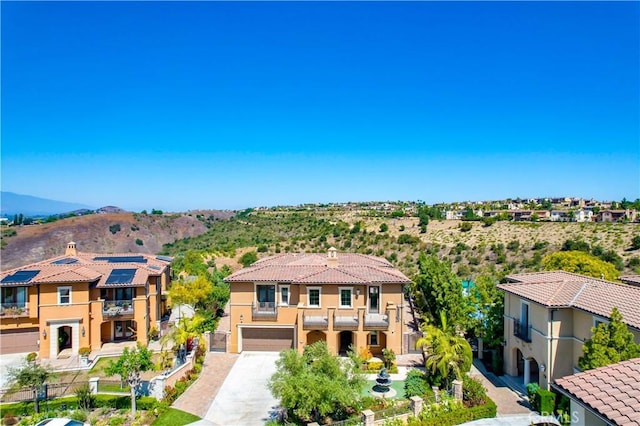 1278 Inspiration, West Covina, CA 91791 - view of front of property featuring driveway, a balcony, an attached garage, stucco siding, and a mountain view