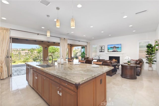 1278 Inspiration, West Covina, CA 91791 - kitchen with recessed lighting, a center island with sink, dishwasher, a warm lit fireplace, and light stone countertops
