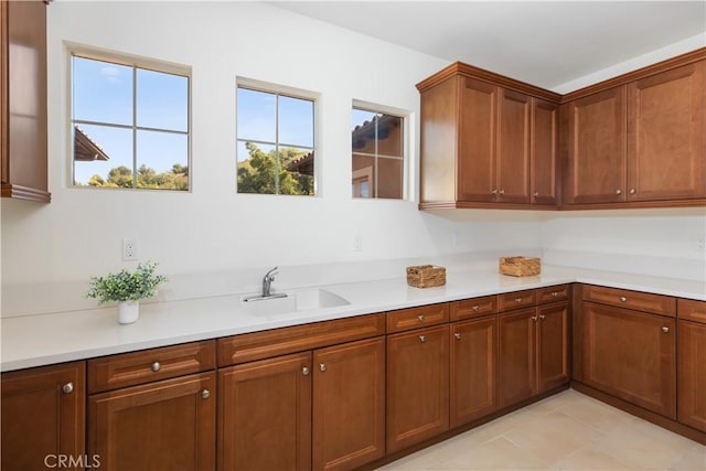 1278 Inspiration, West Covina, CA 91791 - kitchen with light countertops, brown cabinetry, and light tile patterned floors