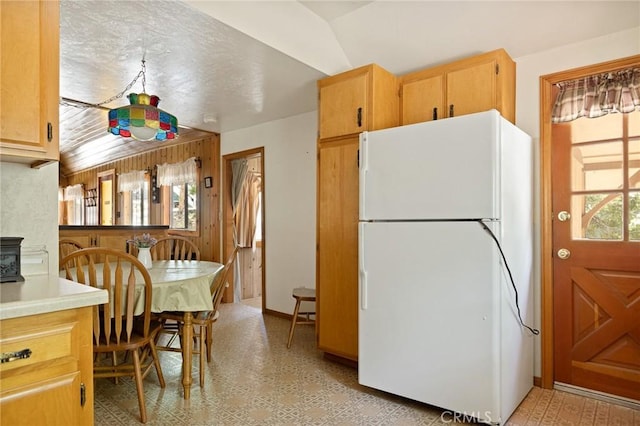 1230 Bear Springs Rd, Rimforest, CA 92378 - kitchen with freestanding refrigerator, light flooring, light countertops, and a wood stove
