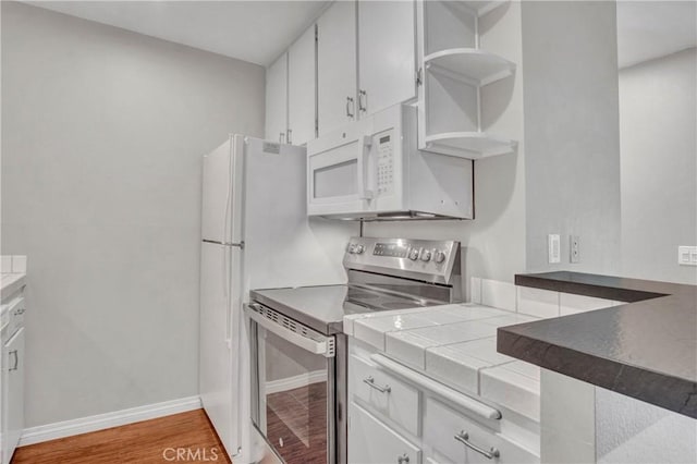 3603 W Hidden Ln Unit 210, Rolling Hills Estates, CA 90274 - kitchen featuring stainless steel range with electric cooktop, white microwave, open shelves, light wood-style floors, and white cabinetry