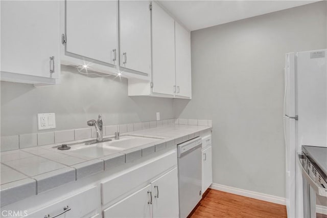 3603 W Hidden Ln Unit 210, Rolling Hills Estates, CA 90274 - kitchen with white appliances, tile counters, white cabinets, and light wood-style floors
