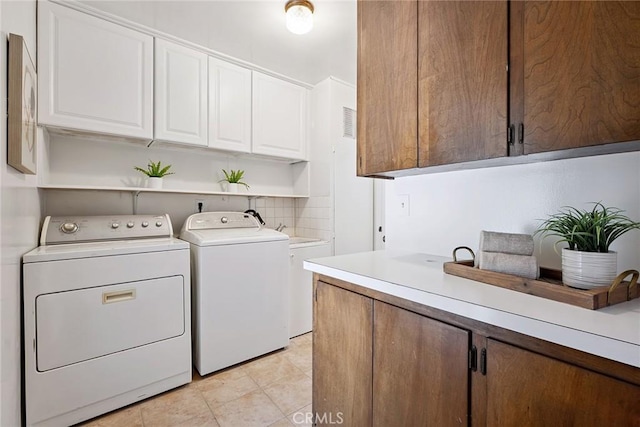 4241 Kingfisher Rd, Calabasas, CA 91302 - laundry room featuring separate washer and dryer and cabinet space