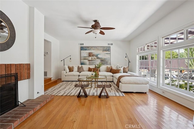 4241 Kingfisher Rd, Calabasas, CA 91302 - living area with wood finished floors, ceiling fan, and a fireplace
