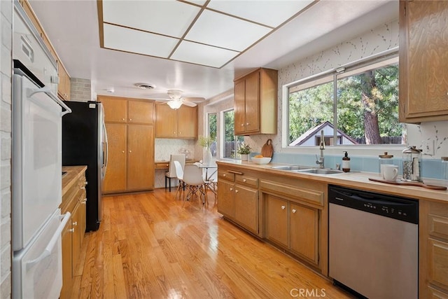 4241 Kingfisher Rd, Calabasas, CA 91302 - kitchen with stainless steel appliances, light wood-style floors, light countertops, backsplash, and ceiling fan