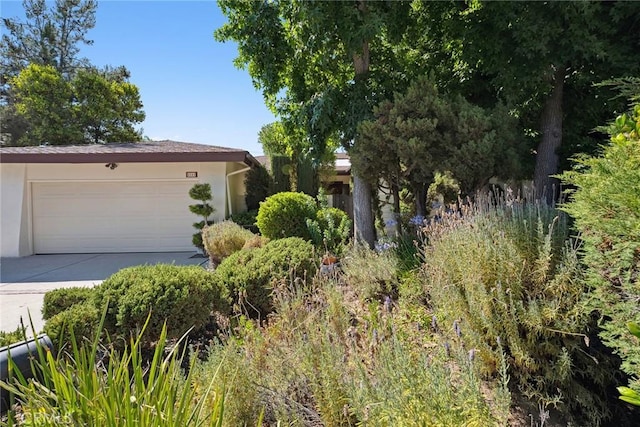 4241 Kingfisher Rd, Calabasas, CA 91302 - obstructed view of property featuring driveway, stucco siding, and a garage