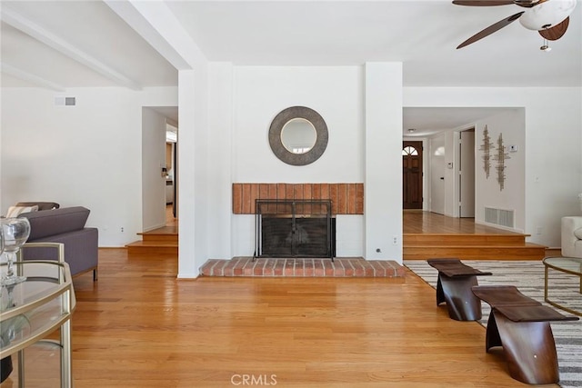 4241 Kingfisher Rd, Calabasas, CA 91302 - living area with wood finished floors, ceiling fan, and a fireplace