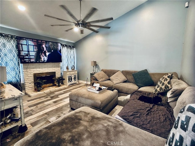 7707 Bolton Ave, Riverside, CA 92503 - living area featuring vaulted ceiling, a fireplace, a ceiling fan, and wood finished floors