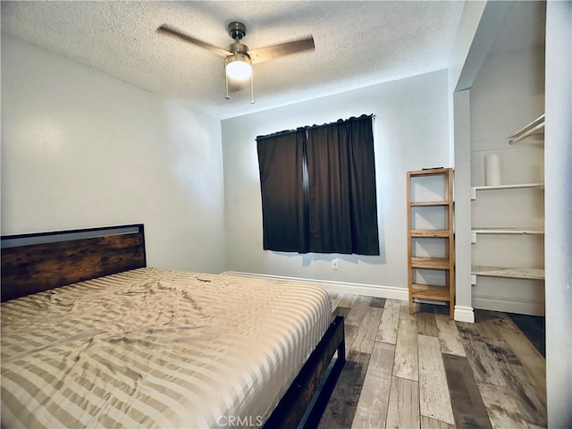 7707 Bolton Ave, Riverside, CA 92503 - bedroom featuring wood finished floors, a textured ceiling, and ceiling fan