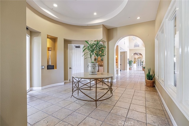 23785 Western Cedar Ct, Valencia, CA 91354 - hall with arched walkways, stone tile floors, and recessed lighting