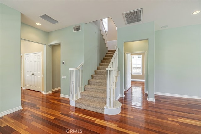 23785 Western Cedar Ct, Valencia, CA 91354 - staircase featuring wood-type flooring, a towering ceiling, and recessed lighting