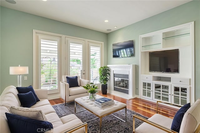 23785 Western Cedar Ct, Valencia, CA 91354 - living room featuring a glass covered fireplace, wood finished floors, and recessed lighting