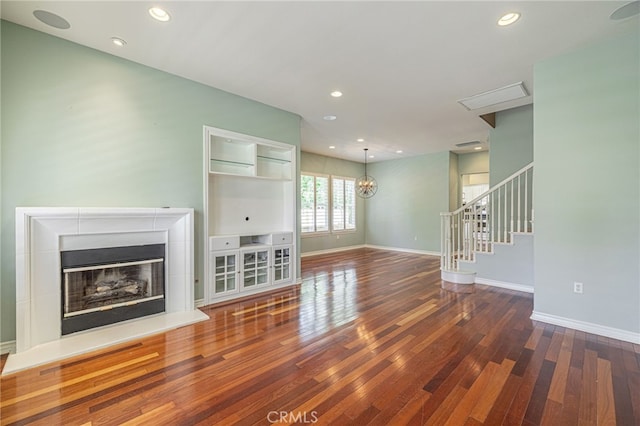 23785 Western Cedar Ct, Valencia, CA 91354 - unfurnished living room featuring wood finished floors, a glass covered fireplace, recessed lighting, and stairway