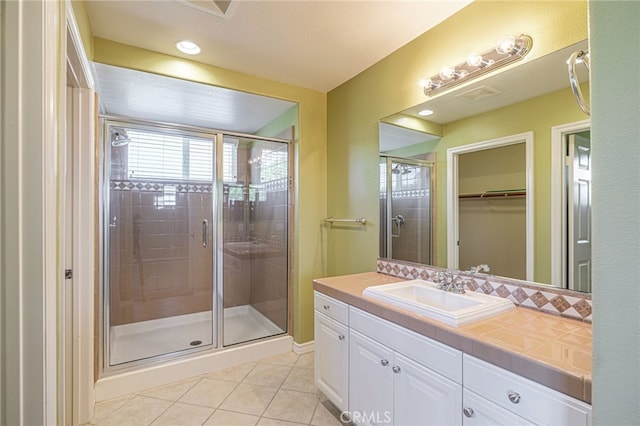 23785 Western Cedar Ct, Valencia, CA 91354 - bathroom with tile patterned flooring, a shower stall, vanity, and a spacious closet
